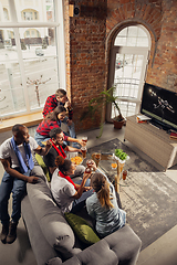 Image showing Excited group of people watching sport match at home