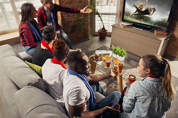 Image showing Excited group of people watching sport match at home