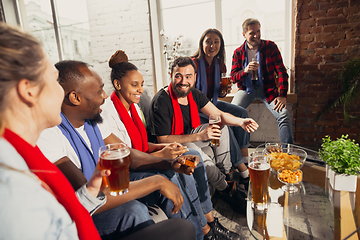 Image showing Excited group of people watching football, sport match at home