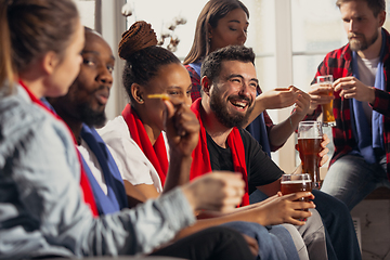 Image showing Excited group of people watching football, sport match at home