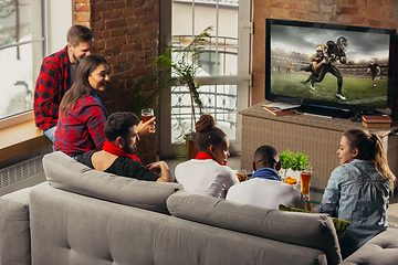 Image showing Excited group of people watching sport match at home