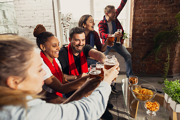 Image showing Excited group of people watching football, sport match at home