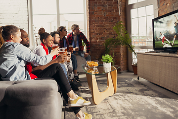 Image showing Excited group of people watching sport match at home