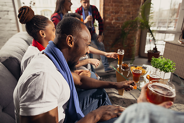 Image showing Excited group of people watching football, sport match at home