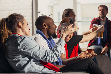 Image showing Excited group of people watching football, sport match at home