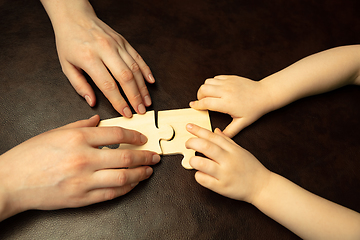 Image showing Close up of female and kid\'s hands doing things together, family, home concept