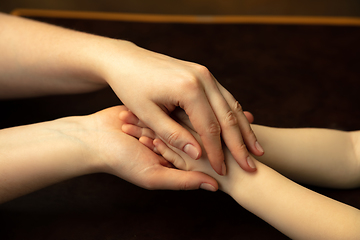 Image showing Close up of female and kid\'s hands doing things together, family, home concept