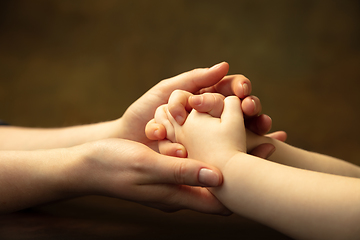 Image showing Close up of female and kid\'s hands doing things together, family, home concept