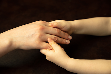 Image showing Close up of female and kid\'s hands doing things together, family, home concept