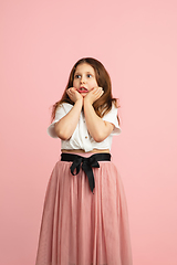 Image showing Pretty caucasian girl portrait isolated on pink studio background with copyspace