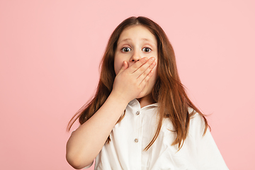 Image showing Pretty caucasian girl portrait isolated on pink studio background with copyspace