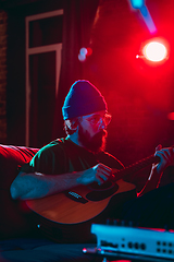 Image showing Close-up of musician performing in neon light. Concept of advertising, hobby, music, festival, entertainment.