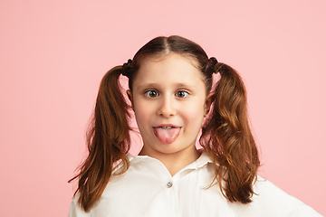 Image showing Pretty caucasian girl portrait isolated on pink studio background with copyspace