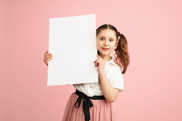 Image showing Pretty caucasian girl portrait isolated on pink studio background with copyspace