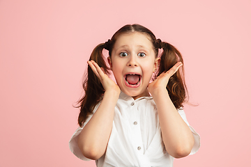 Image showing Pretty caucasian girl portrait isolated on pink studio background with copyspace