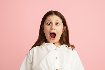 Image showing Pretty caucasian girl portrait isolated on pink studio background with copyspace