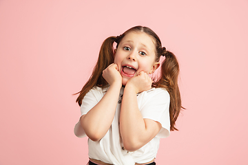 Image showing Pretty caucasian girl portrait isolated on pink studio background with copyspace