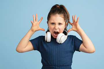 Image showing Pretty caucasian girl portrait isolated on blue studio background with copyspace