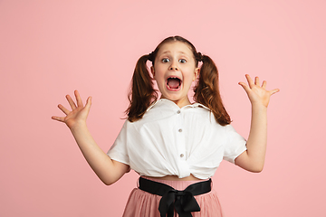 Image showing Pretty caucasian girl portrait isolated on pink studio background with copyspace