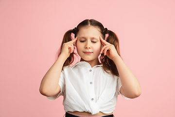 Image showing Pretty caucasian girl portrait isolated on pink studio background with copyspace