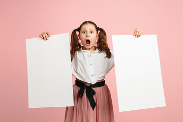 Image showing Pretty caucasian girl portrait isolated on pink studio background with copyspace