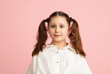 Image showing Pretty caucasian girl portrait isolated on pink studio background with copyspace