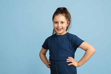 Image showing Pretty caucasian girl portrait isolated on blue studio background with copyspace