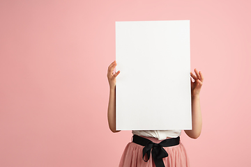 Image showing Pretty caucasian girl portrait isolated on pink studio background with copyspace