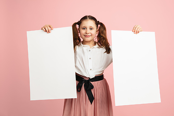 Image showing Pretty caucasian girl portrait isolated on pink studio background with copyspace