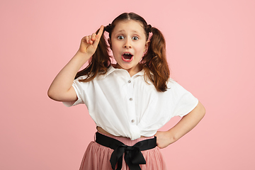 Image showing Pretty caucasian girl portrait isolated on pink studio background with copyspace