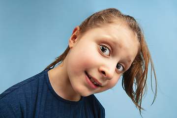 Image showing Pretty caucasian girl portrait isolated on blue studio background with copyspace