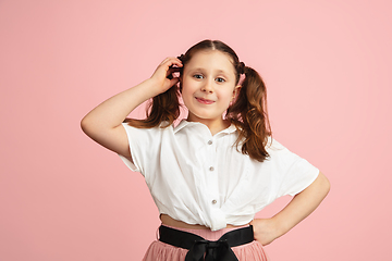 Image showing Pretty caucasian girl portrait isolated on pink studio background with copyspace