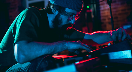 Image showing Close-up of musician performing in neon light. Concept of advertising, hobby, music, festival, entertainment.