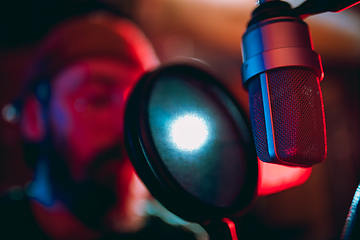 Image showing Close-up of musician performing in neon light. Concept of advertising, hobby, music, festival, entertainment.