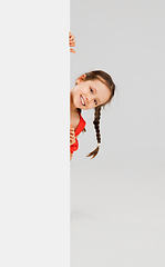 Image showing Happy kid, girl isolated on white studio background. Looks happy, cheerful, sincere. Copyspace. Childhood, education, emotions concept