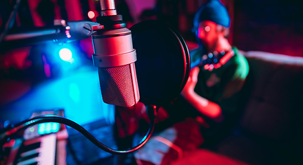 Image showing Close-up of musician performing in neon light. Concept of advertising, hobby, music, festival, entertainment.