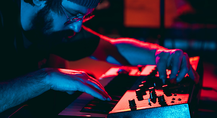 Image showing Close-up of musician performing in neon light. Concept of advertising, hobby, music, festival, entertainment.