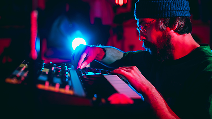 Image showing Close-up of musician performing in neon light. Concept of advertising, hobby, music, festival, entertainment.