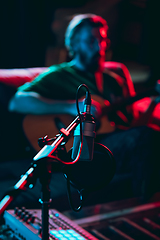 Image showing Close-up of musician performing in neon light. Concept of advertising, hobby, music, festival, entertainment.