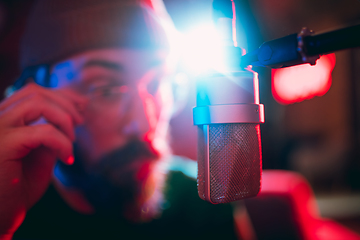 Image showing Close-up of musician performing in neon light. Concept of advertising, hobby, music, festival, entertainment.