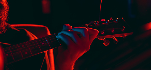 Image showing Close-up of musician performing in neon light. Concept of advertising, hobby, music, festival, entertainment.