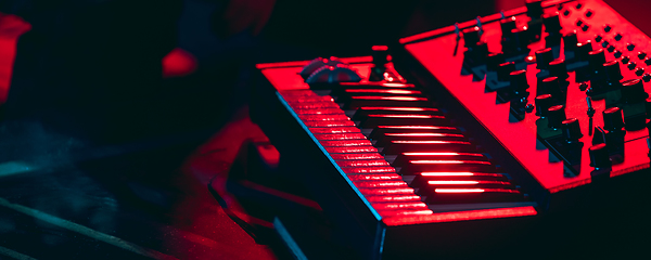 Image showing Close-up of musicial equipment for performing in neon light. Concept of advertising, hobby, music, festival, entertainment.