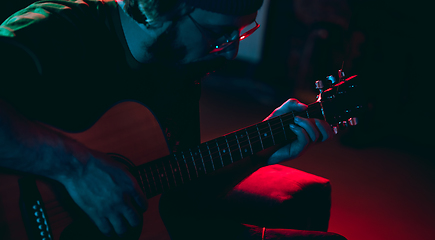 Image showing Close-up of musician performing in neon light. Concept of advertising, hobby, music, festival, entertainment.