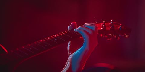 Image showing Close-up of musician performing in neon light. Concept of advertising, hobby, music, festival, entertainment.