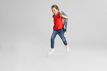 Image showing Happy kid, girl isolated on white studio background. Looks happy, cheerful, sincere. Copyspace. Childhood, education, emotions concept