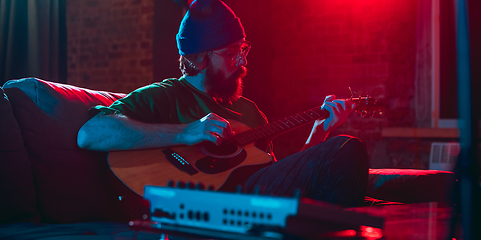 Image showing Close-up of musician performing in neon light. Concept of advertising, hobby, music, festival, entertainment.