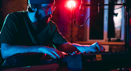 Image showing Close-up of musician performing in neon light. Concept of advertising, hobby, music, festival, entertainment.