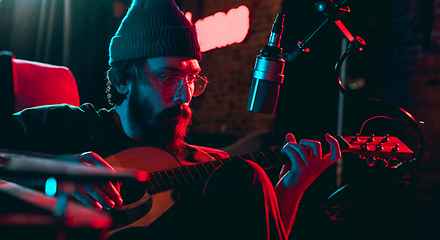 Image showing Close-up of musician performing in neon light. Concept of advertising, hobby, music, festival, entertainment.