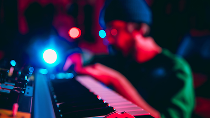 Image showing Close-up of musician performing in neon light. Concept of advertising, hobby, music, festival, entertainment.