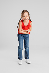 Image showing Happy kid, girl isolated on white studio background. Looks happy, cheerful, sincere. Copyspace. Childhood, education, emotions concept